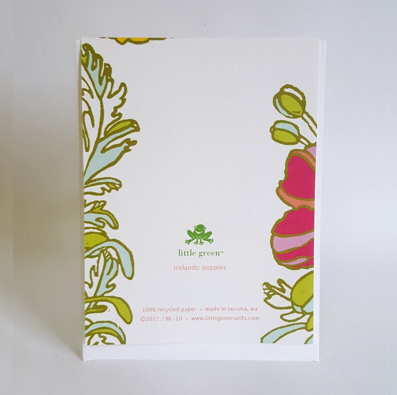 May include: A white card with green and yellow floral designs on the edges. The card has the text "little green&trade; icelandic poppies" in green text. The bottom of the card has the text "100% recycled paper made in tacoma, wa &copy;2017/BK-10 www.littlegreencards.com" in black text.