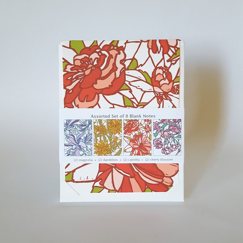 May include: Assorted set of 8 blank notes featuring floral designs. The designs include magnolia, dandelion, camillia, and cherry blossom.