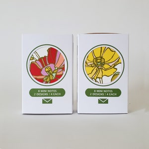 May include: Two boxes of mini notes with floral designs. The box on the left has a red, pink, and white floral design. The box on the right has a yellow and white floral design. Both boxes have the text "8 mini notes 2 designs | 4 each" and an envelope icon.