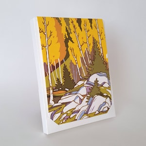 May include: A canvas art print featuring a stylized landscape with yellow and green trees, white birch trees, and blue and gray rocks. The artwork is set against a white background.