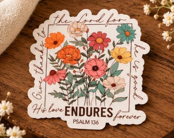 May include: A die-cut sticker featuring a bouquet of colorful flowers in shades of orange, pink, yellow, and teal. The text reads: Give thanks to the Lord for he is good. His love ENDURES forever. PSALM 136, framed in a thin brown border.