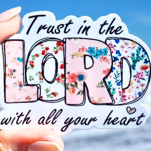 May include: A white sticker with a floral design and the text "Trust in the LORD with all your heart".
