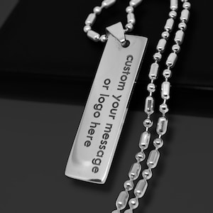 May include: A silver necklace with a rectangular pendant that says "custom your message or logo here".