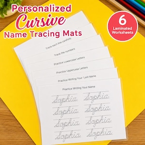 May include: Six laminated name tracing worksheets are stacked on a yellow surface. The worksheets feature black cursive writing prompts, including tracing letters and names. The top of the stack reads "Personalized Cursive Name Tracing Mats". A red circle reads "6 Laminated Worksheets".