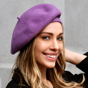 The model is wearing a lavender color wool beret.