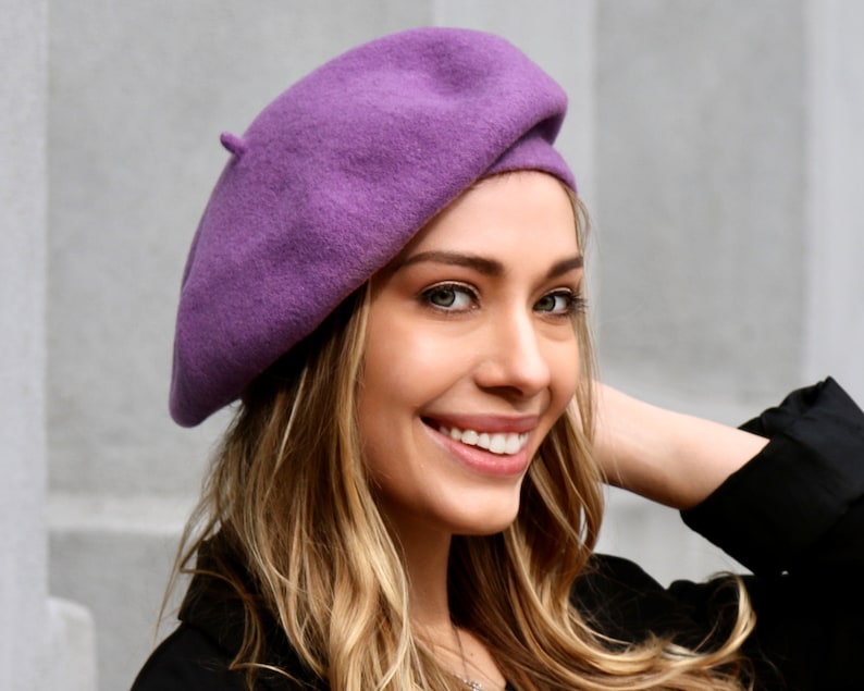 The model is wearing a lavender color wool beret.