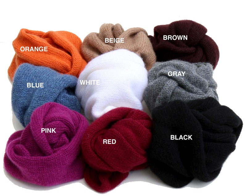 May include: Ten different colored knitted scarves in a variety of colors including orange, beige, brown, gray, white, pink, red, black, and blue.