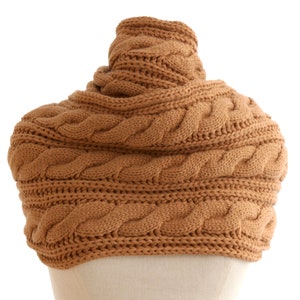 May include: A brown cable knit cowl neck scarf. The scarf is made of a soft, warm material and is perfect for keeping you warm in the winter.