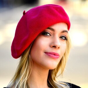 The model is wearing a red beret.