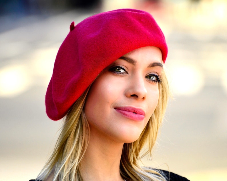 The model is wearing a red beret.