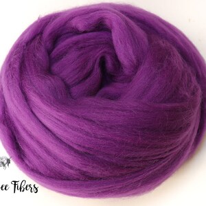 May include: A close-up of a purple wool roving, a type of fiber used for felting and spinning.