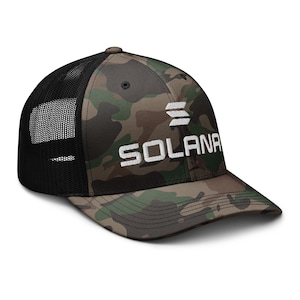 May include: A black and green camouflage trucker hat with a white embroidered logo that says "SOLANA" with three horizontal lines above the text.