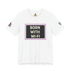 May include: A white short-sleeve t-shirt featuring a central black rectangular graphic with the white text BORN WITH WI-FI enclosed in a thin pink border. The shirt includes a small logo on the left sleeve and a QR code on the right sleeve.