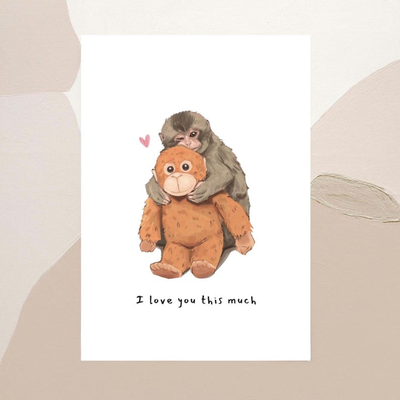 May include: A greeting card featuring an illustration of a gray monkey hugging a brown stuffed animal. A small pink heart floats above them. The text "I love you this much" is printed below the illustration.