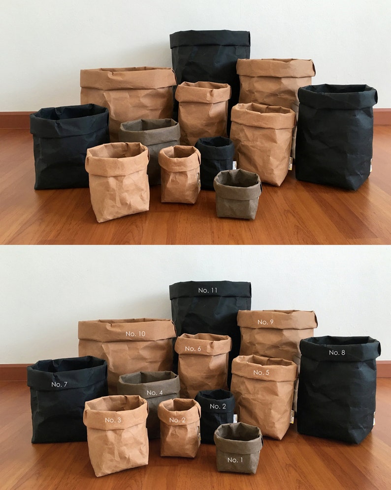 Puede incluir: Un conjunto de 11 bolsas de papel marr&oacute;n y negro de varios tama&ntilde;os. Las bolsas est&aacute;n numeradas del 1 al 11.