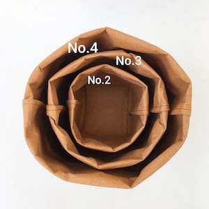 Puede incluir: Tres bolsas de papel marr&oacute;n, anidadas una dentro de la otra, con los n&uacute;meros "No. 2", "No. 3" y "No. 4" escritos en ellas.
