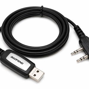 May include: Black USB programming cable for two-way radios. The cable features a USB connector, a 2.5mm and 3.5mm audio jack, and a rectangular connector with the "BAOFENG" logo. The cable is coiled and lies on a white background.