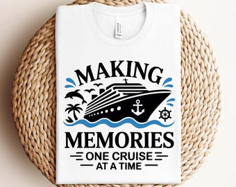 May include: White t-shirt with a black and blue graphic. The design features a cruise ship, waves, and the text "MAKING MEMORIES ONE CRUISE AT A TIME."