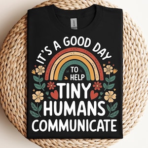 May include: Black t-shirt with a rainbow and the text "It's a good day to help tiny humans communicate".