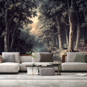 Puede incluir: Una sala de estar con un gran mural de pared que representa un bosque oscuro con un camino que conduce hacia el bosque. El mural está detrás de un sofá seccional blanco con almohadas grises. Una pequeña mesa de café y un otomano gris están frente al sofá.