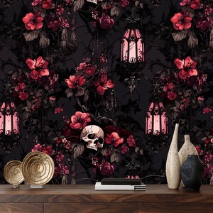 May include: A dark floral wallpaper with a gothic theme featuring skulls, lanterns, and vines. The wallpaper is a dark gray color with pink flowers and black accents.