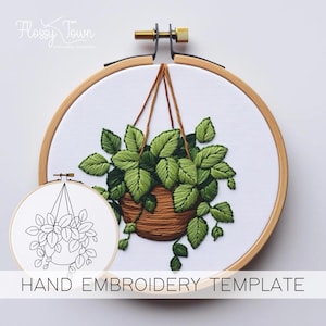 May include: A hand embroidery template featuring a hanging potted plant with green leaves. The template is printed on white fabric and is ready to be stitched.
