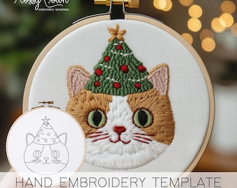 May include: Hand embroidery template featuring a cat wearing a Christmas tree hat. The template is printed on white fabric and is ready to be stitched. The cat has a white face with orange fur and green eyes.