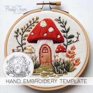 May include: Hand embroidery template featuring a mushroom house with a red cap, white spots, and a brown door. The house is surrounded by green foliage and other mushrooms.