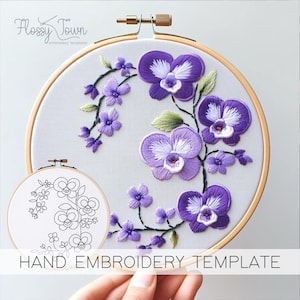 May include: A hand embroidery template featuring a design of purple orchids with green leaves and stems. The template is displayed in a wooden embroidery hoop. The text "HAND EMBROIDERY TEMPLATE" is printed below the hoop.