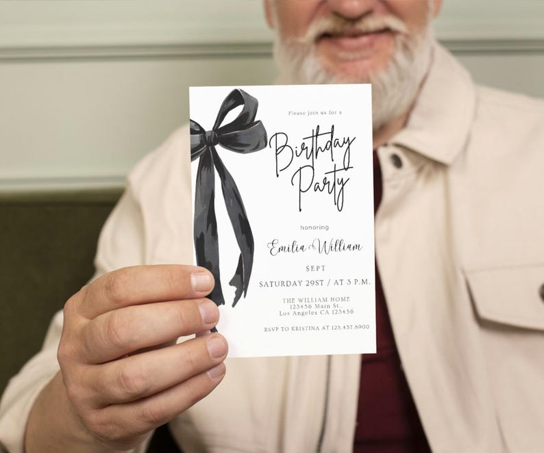 May include: A white invitation card with a black watercolor bow and the words "Birthday Party" in elegant script. The card also includes event details: date, time, and location. The invitation is held by a person.