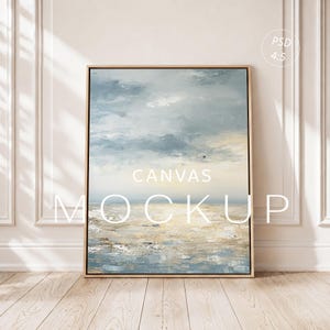 May include: A rectangular canvas print in a light wood frame featuring an abstract landscape painting with textured brushstrokes in shades of blue, gray, and cream. The text "CANVAS MOCKUP" and "PSD 4:5" is overlaid on the artwork.