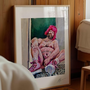 May include: A framed artwork featuring a seated figure wearing a pink hat and sneakers. The painting has a nude figure with a beard, set against a green and white background. The artwork is displayed in a room with wooden paneling.