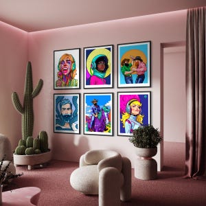 May include: A collection of six framed pop art prints displayed on a pink wall. The art features colorful portraits of people with headphones, cowboys, and other figures. The room includes a cactus, a modern chair, and a potted plant, all in a pink and neutral color scheme.