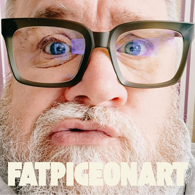 May include: Close-up of a person wearing dark olive green eyeglasses with a thick frame. The person has blue eyes, a white beard, and the text "FATPIGEONART" in a cream color at the bottom of the image.