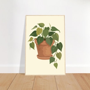 Peut inclure: Une impression murale encadrée représentant une illustration numérique d'une plante philodendron verte retombante dans un pot en terre cuite. La plante présente des feuilles en forme de cœur dans diverses nuances de vert sur un fond crème uni.