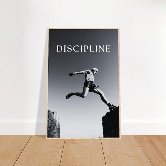 Poster encadré homme sautant entre deux rochers, affiche discipline et dépassement de soi, déco murale bureau salle de sport