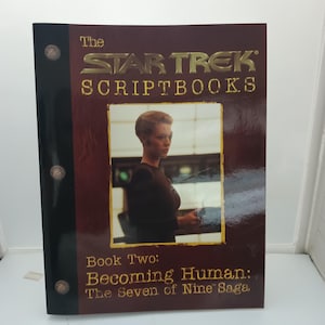 May include: A Star Trek Scriptbooks book with a maroon cover. The title "The Star Trek Scriptbooks" is in gold lettering. The book features an image of a woman and the text "Book Two: Becoming Human: The Seven of Nine Saga."