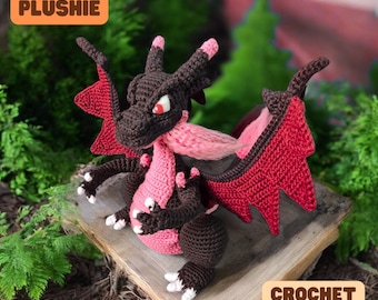 May include: Crochet pattern for a red and brown dragon plushie. The dragon has pink accents and a large, red wing. The pattern is available for download.