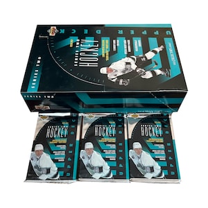 May include: A teal and black Upper Deck Series Two Hockey box set with three unopened packs. The box features a hockey player image and the text "Series Two." Each pack displays a hockey player and the word "Hockey."
