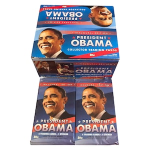 2 paquets de cartes à collectionner vintage du président Obama. 6 cartes + 1 sticker par paquet. Publié par Topps.