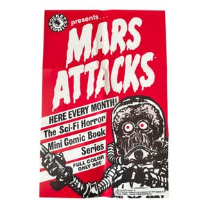 以下が含まれることがあります： 大きな白い文字で「MARS ATTACKS」と書かれた赤いポスター。ポスターには、火星人の白黒イラストと「The Sci-Fi Horror Mini Comic Book Series」というテキストが描かれています。