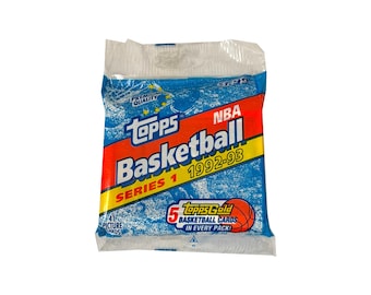May include: A sealed pack of 1992-93 Topps NBA Basketball Series 1 trading cards. The blue plastic wrapper features a red and yellow diagonal stripe with the text Topps Basketball Series 1 1992-93 and a graphic of a basketball with 5 cards.