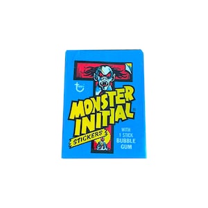 Monster Initial Stickers vintage wax pack. Monster stickers and bubble gum in every pack! Topps 1974. Very nice overall condition.