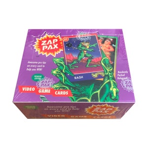 Werkseitig versiegelte Schachtel mit Zap Pax Vintage-Videospiel-Sammelkarten. 36 Packungen mit je 8 Karten. Tolle Profi-Tipps auf jeder Karte helfen dir zu gewinnen! 1992.