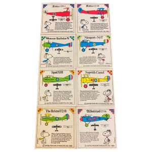Set of 8 Snoopy + military aircraft stickers. Included with Wonderbread in 1965. Stickers measure 3 x 3 and are in excellent condition.