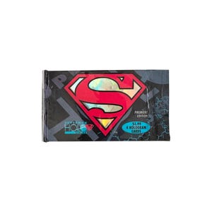 May include: A rectangular foil pack of Superman Holo Series trading cards. The black wrapper features a large red and yellow holographic Superman shield logo, the text Premiere Edition, and a blue oval stating 4 Hologram Cards.