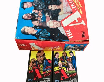 2 packs of The A-Team vintage trading cards. Each sealed wax pack contains 10 cards, 1 sticker, and 1 (inedible) stick of gum. Topps 1983.