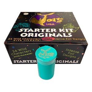 May include: A black cardboard box labeled Jots USA Starter Kit Originals with 24 Wild Characters and Intense Foil Designs, featuring colorful confetti graphics. In front sits a solid teal plastic cylindrical container with a matching lid.
