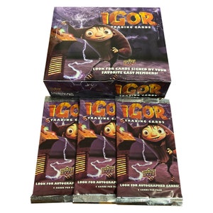 May include: Three packs of Igor trading cards featuring the animated character Igor on the front. The packs are purple and black with lightning bolts and the text "Igor Trading Cards".