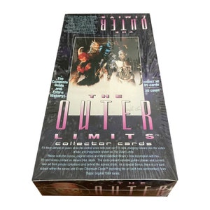 May include: A sealed box of The Outer Limits collector cards. The box features a black and white image of three characters from the show, including a humanoid alien, a robot, and a human. The box also features the show's logo and the text "Collector Cards".